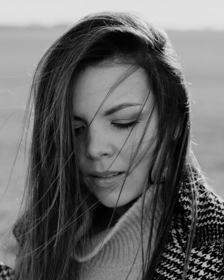 grayscale photo of woman in knit sweater